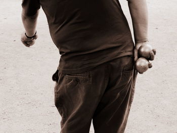 Rear view of man holding umbrella