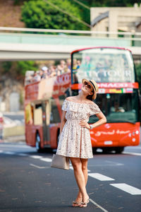 Full length of woman standing on road