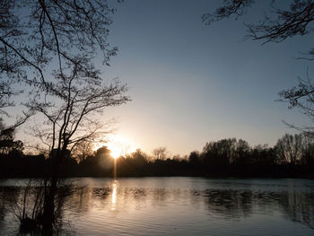 Scenic view of lake against sky during sunset