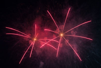 Low angle view of firework display at night