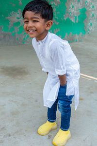 Portrait of smiling boy standing outdoors