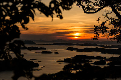 Scenic view of sea against dramatic sky during sunset