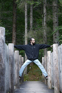 Portrait of young man standing in forest