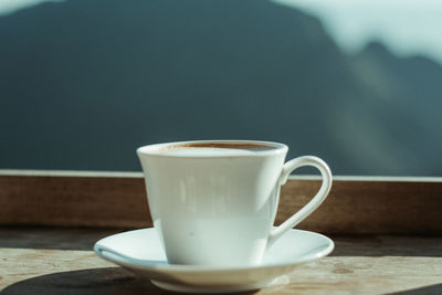 Close-up of coffee cup on table