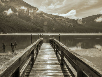 Pier over lake against sky