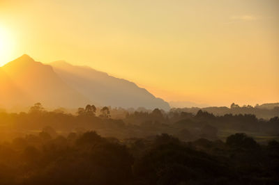 Scenic view of silhouette mountains against sky during sunset