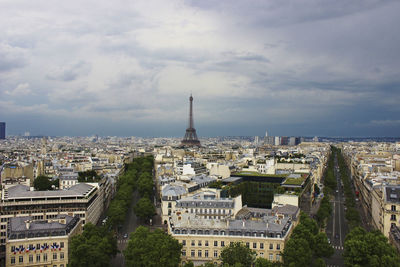 High angle view of city buildings against cloudy sky