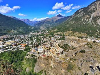 High angle view of townscape and mountains against sky