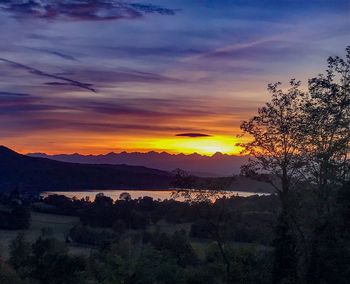 Scenic view of silhouette mountains against sky at sunset