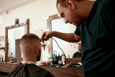 Side view of man working at clinic