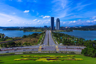 Bridge over river in city against sky