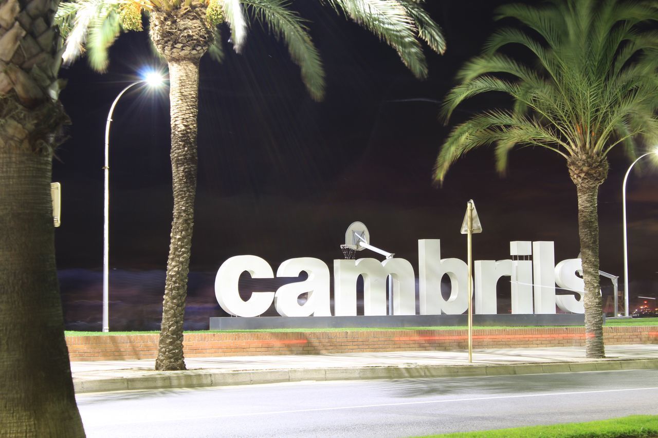 INFORMATION SIGN ON STREET AT NIGHT