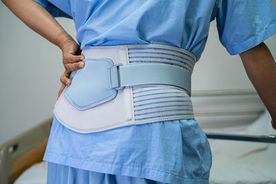 Midsection of patient wearing belt having backache