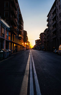 Surface level of road amidst buildings against sky