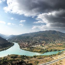 Aerial view of buildings and mountains against sky