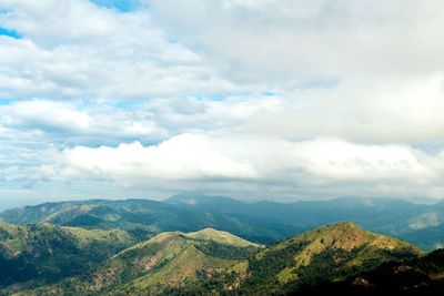 Scenic view of mountains against cloudy sky