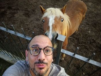 High angle view of man with horse at ranch