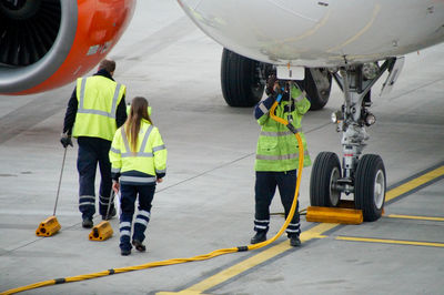 Full length of people working at airport