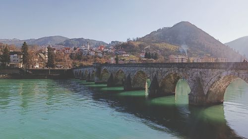 Bridge over river against clear sky