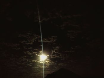 Low angle view of illuminated light against sky at night