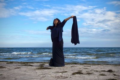 Silhouette of woman standing on beach