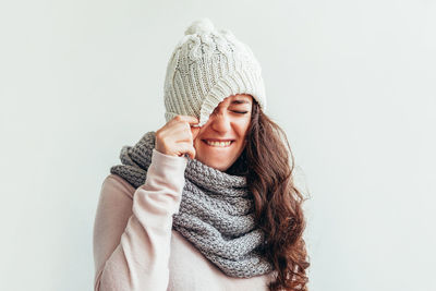 Young woman wearing hat against white background