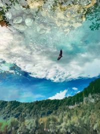 Low angle view of man standing on mountain against sky