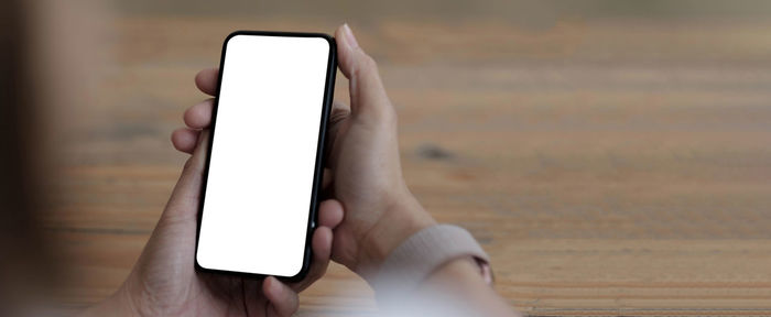 Close-up of hand holding mobile phone