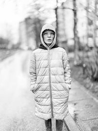 Portrait of young man standing in snow