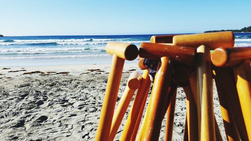 Close-up of yellow sand at beach against clear sky