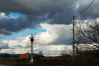 Low angle view of communications tower against the sky