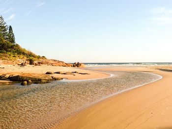 Scenic view of beach against clear sky