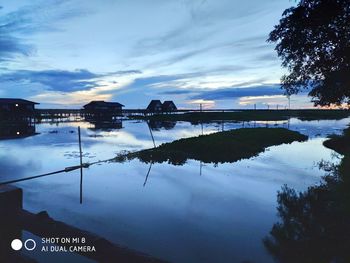 Scenic view of lake against sky at sunset