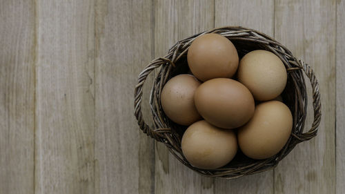 High angle view of eggs in basket on table