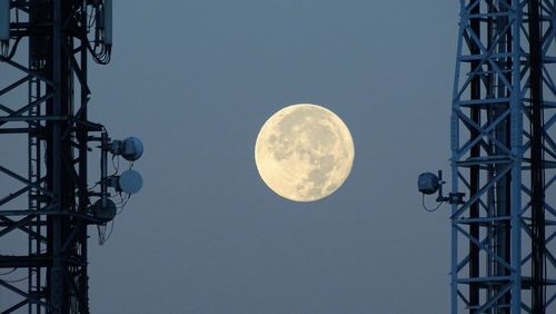 Low angle view of moon against clear sky at night