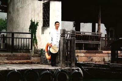 Full length of man standing against building