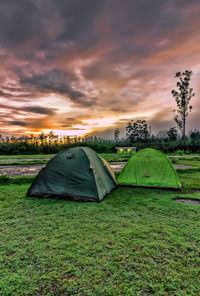 Tent on field against cloudy sky