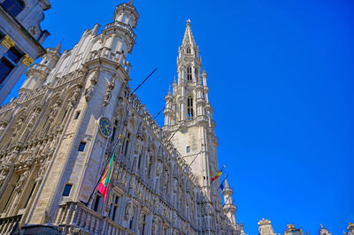 Low angle view of buildings against blue sky