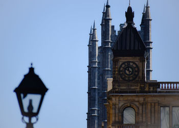 Low angle view of clock tower and building against sky