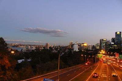 High angle view of illuminated city buildings against sky