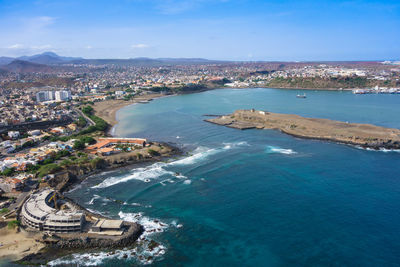 High angle view of sea and buildings against sky