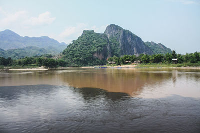 Scenic view of lake and mountains against sky