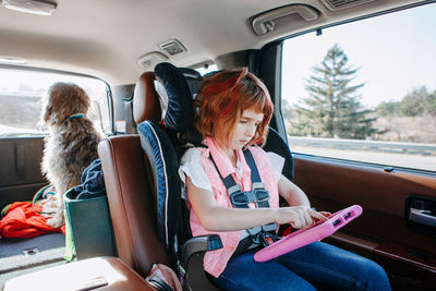 Rear view of women sitting in car