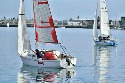 Boats sailing in sea against sky