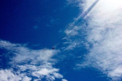 Low angle view of vapor trails in sky