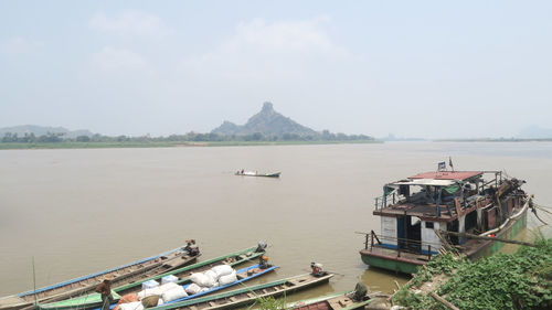 High angle view of boats moored in sea against sky