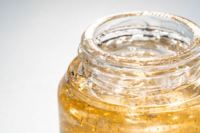 Close-up of glass jars against white background