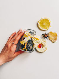 Cropped hand of woman holding food on table