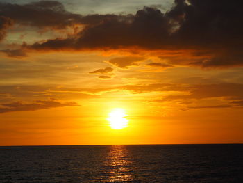 Scenic view of sea against orange sky