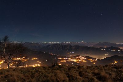 Scenic view of illuminated mountains against sky at night